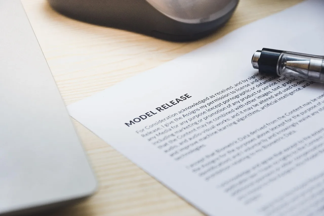 paper, model release, form, document, signing, pen, desk, agreement, business, contract, signature. Rejected athlete lookalikes pair: what to fix before resubmitting